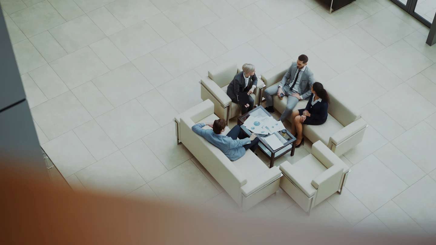 Business team reviewing financial charts in a modern office lobby