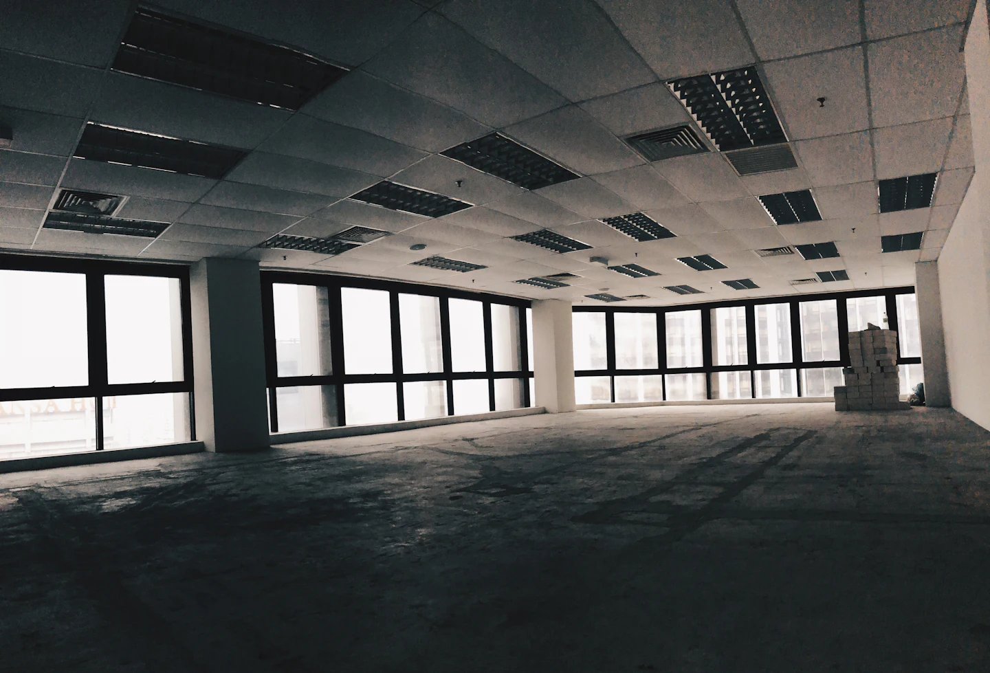 Vacant concrete office interior prepared for redevelopment